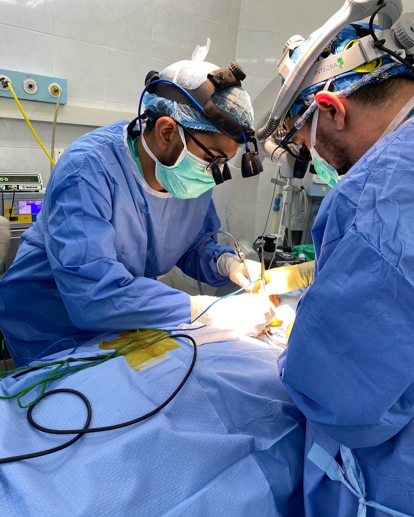 Dr. Desai and a fellow surgeon performing spine surgery in Vientiane, Laos